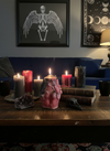 Pink candle in dark living room